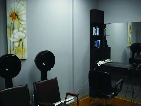 Hair salon with styling chairs and hooded dryers.