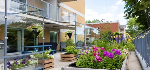 Outdoor terrace with flower planters and glass railings