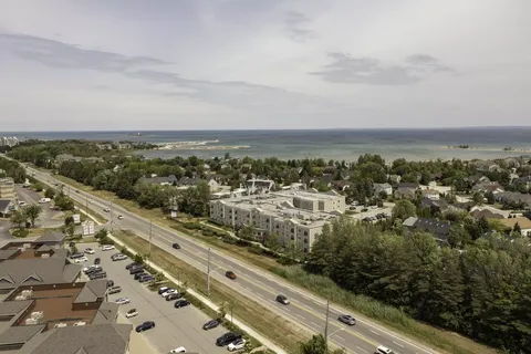 Aerial view of the residence beside a road, with a lake in the distance