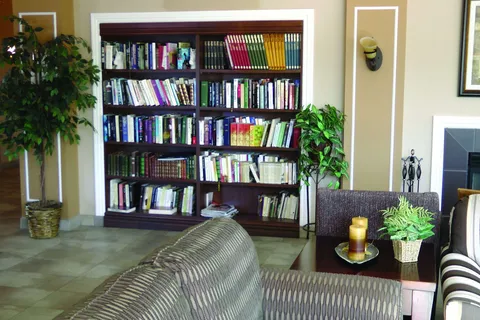 Library corner with bookshelves and seating.