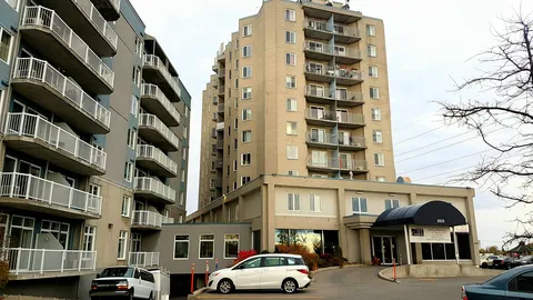 Residence towers with balconies beside the entrance driveway.