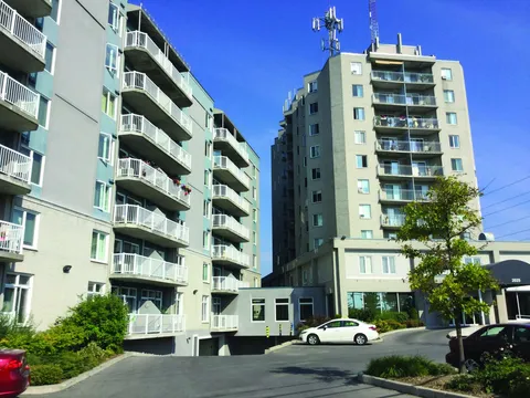 Residence towers and balconies beneath a clear sky.