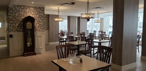 Dining room with wooden tables and chairs.