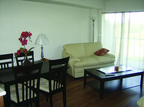 Suite living and dining area with a sofa and table.