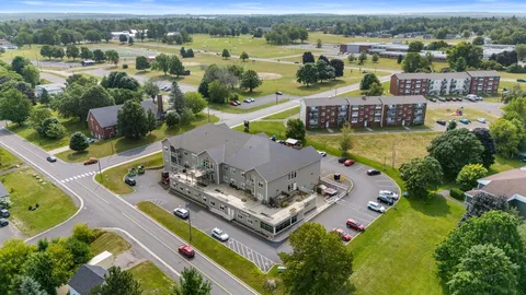Aerial view of the residence, parking area, surrounding streets and lawns
