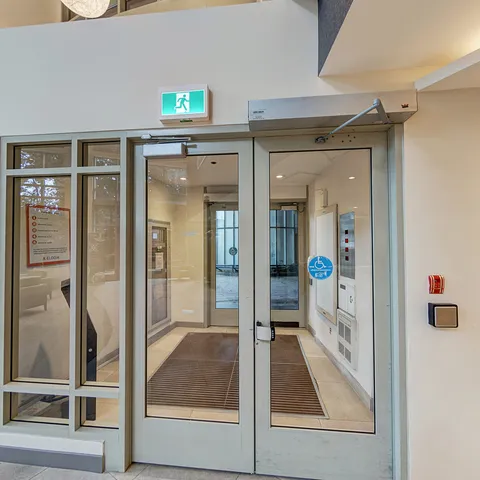Glass doors beside tiled flooring at an interior entrance