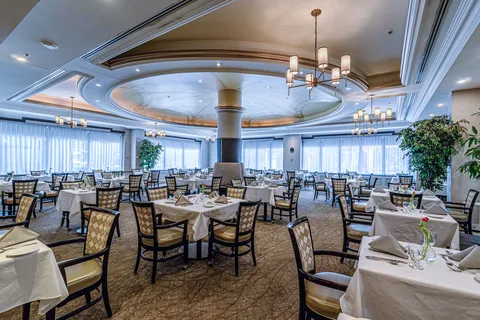 Dining room with set tables and patterned upholstered chairs
