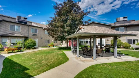 Garden courtyard with a gazebo, lawn and paths between residence wings.