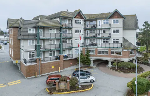 Residence exterior with balconies and a covered driveway entrance