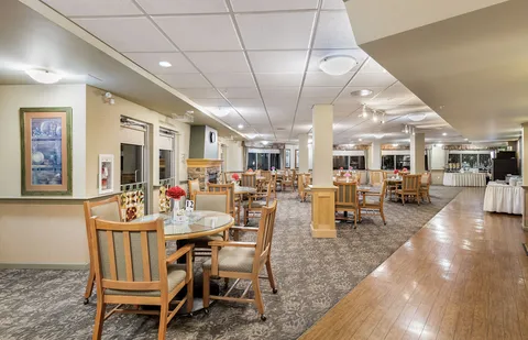 Dining room with round wooden tables, chairs and a wood floor