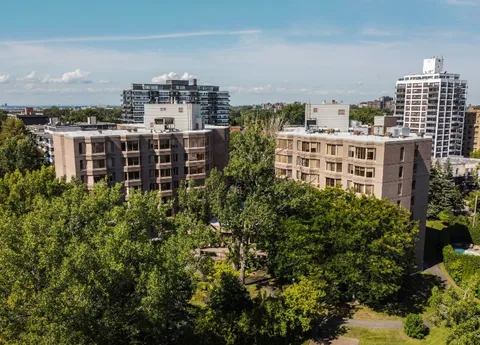 Aerial view of the residence buildings surrounded by mature trees.