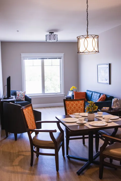 Suite with dining table, chairs, sofa and hanging light
