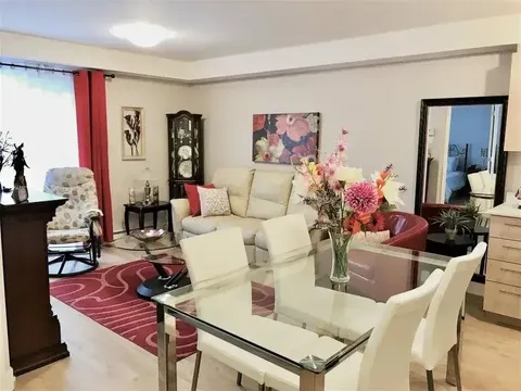 Furnished apartment living and dining area.