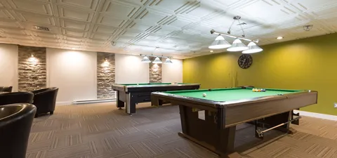 Billiards room with two pool tables