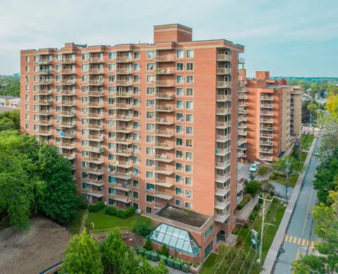 Aerial view of tall brick residential buildings with balconies
