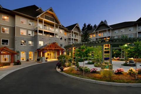 Residence entrance and landscaped driveway at dusk.