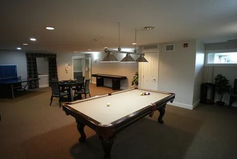 Games room with a billiards table and seating