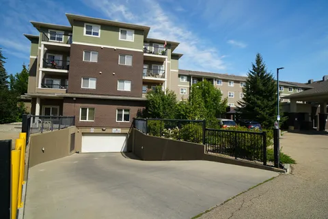 Multi-storey residence beside a driveway and landscaped beds