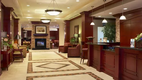 Lobby with a reception desk, seating and a fireplace.