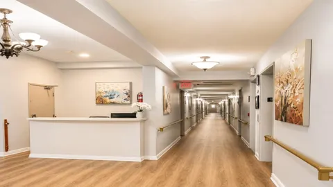 Reception counter beside a hallway with wood-effect flooring.