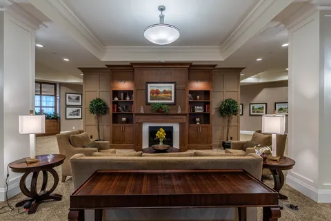 Lounge with sofas and armchairs facing a fireplace