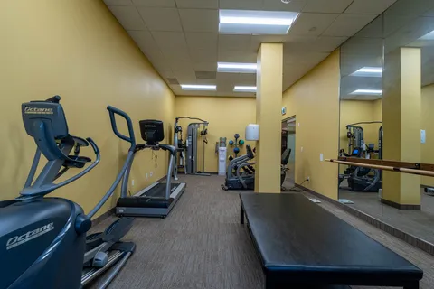 Exercise room with fitness equipment and mirrored walls