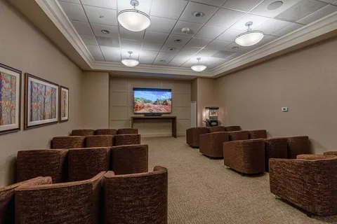 Rows of armchairs facing a screen showing a landscape