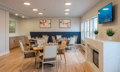 Dining room with set tables and cream chairs