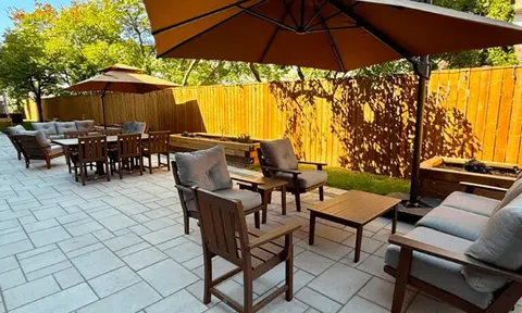 Patio seating beneath a large parasol