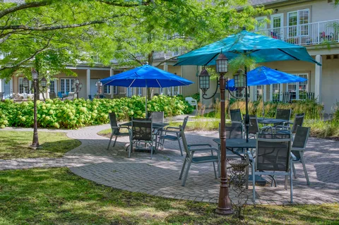Garden patio with umbrella tables and landscaped beds
