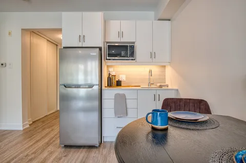 Suite kitchenette with a refrigerator, microwave and dining table