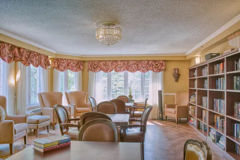 Library with bookshelves and reading tables beside large windows
