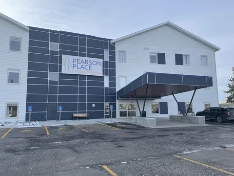 Residence exterior with blue panels and a covered front entrance