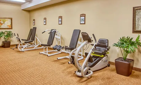 Fitness room with exercise bikes and strength equipment.