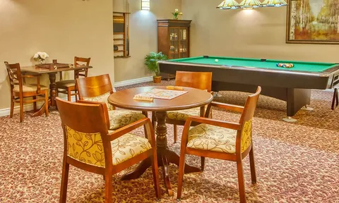 Games room with a billiards table and card tables.