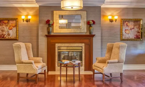 Fireplace seating area with two upholstered armchairs.