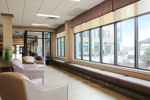 Hallway with armchairs and large windows