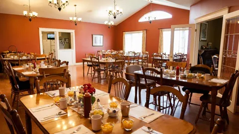 Dining room with set tables and chandeliers.