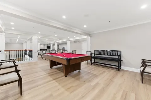 Games room with a billiards table and benches.