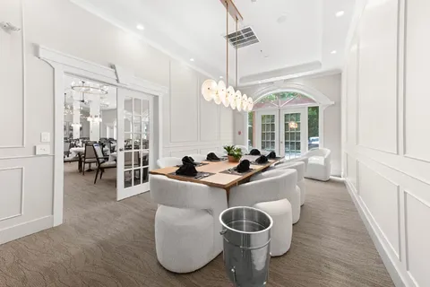 Private dining room with a table and upholstered chairs.
