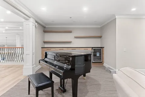 Lounge with a grand piano and upholstered seating.