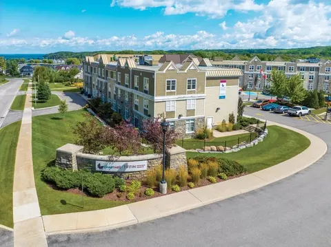 Aerial view of the residence beside parking areas, roads and lawns