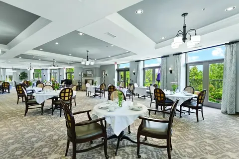 Dining room with set tables and upholstered chairs