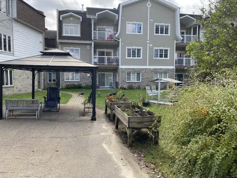 Courtyard with a gazebo, raised garden beds and turkeys beside the residence