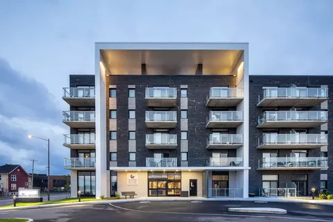 Residence with balconies and an illuminated covered entrance