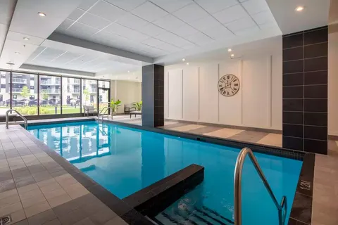 Indoor swimming pool beside large windows