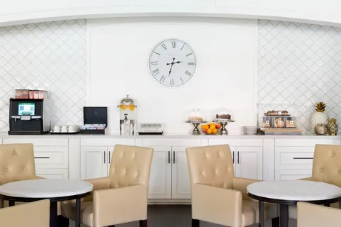 Bistro tables and chairs beside a tiled counter.