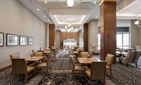 Dining room with wood tables and upholstered chairs