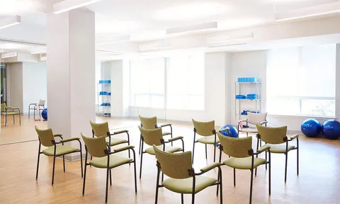 Fitness room with exercise equipment and chairs