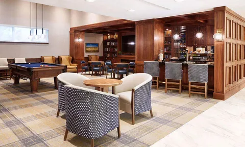 Lounge with billiards table, bar and wood cabinets